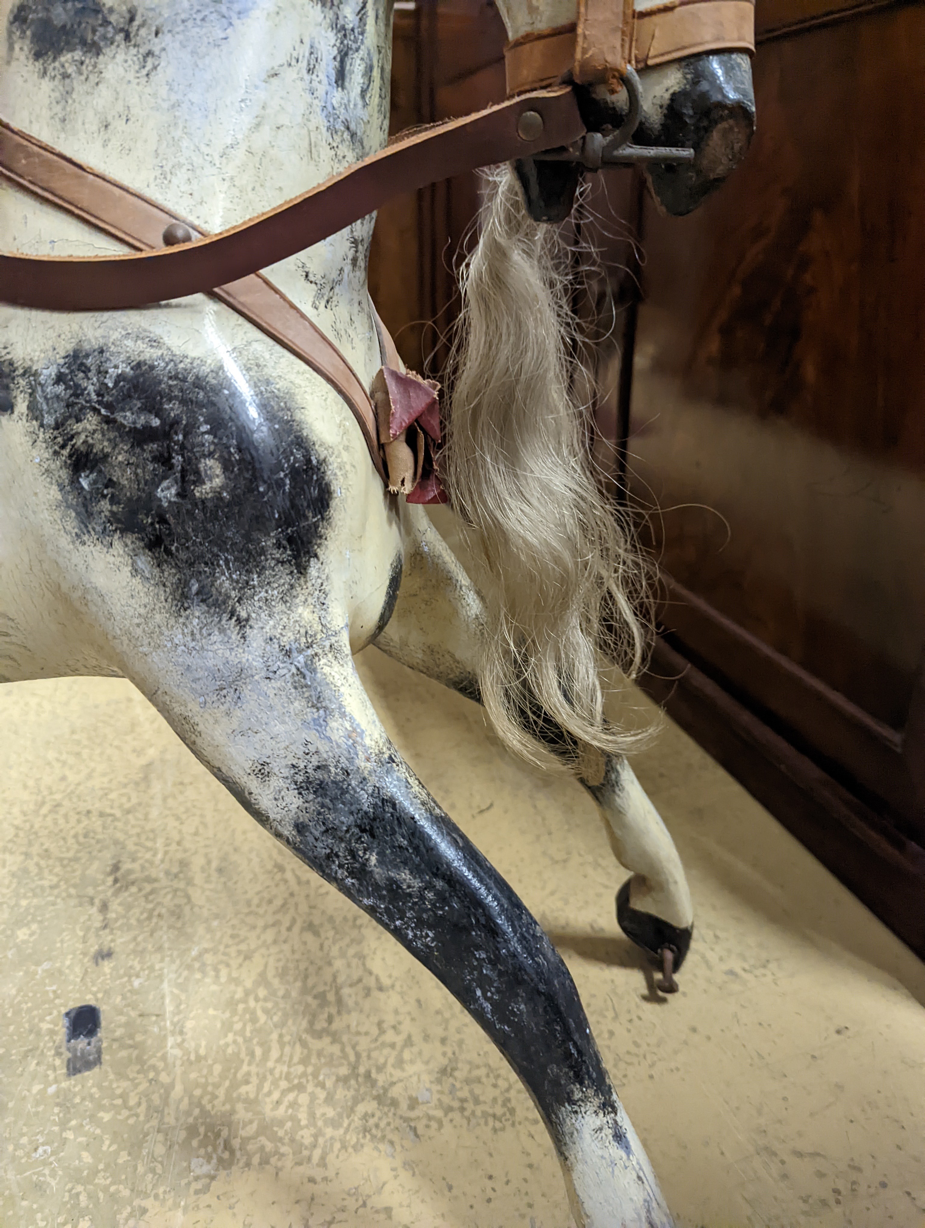 A Victorian carved and painted wood rocking horse, lacking underframe, length 77cm and two painted wood hobby horses, 58cm and 38cm